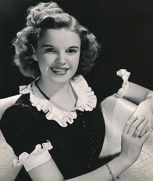 1939 MGM promotional still of Judy Garland as Dorothy — the cultural reference point at the center of the adaptation chain