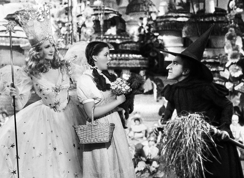 1939 film still of the Wicked Witch, Glinda, and Dorothy